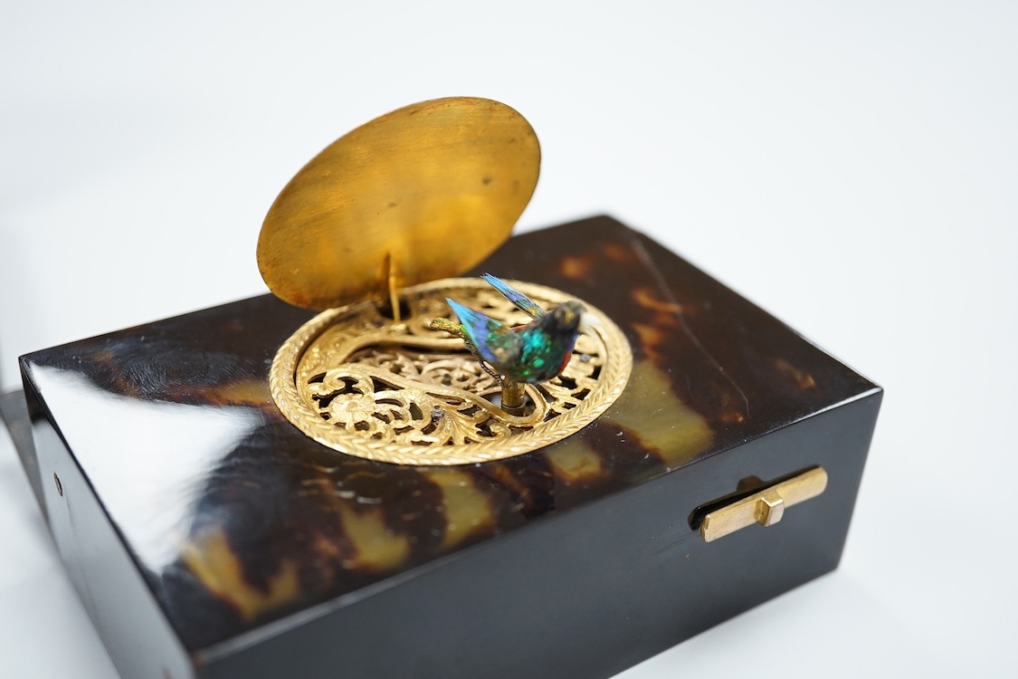 A Victorian white and yellow mounted singing automaton bird music box, damaged, with case and key